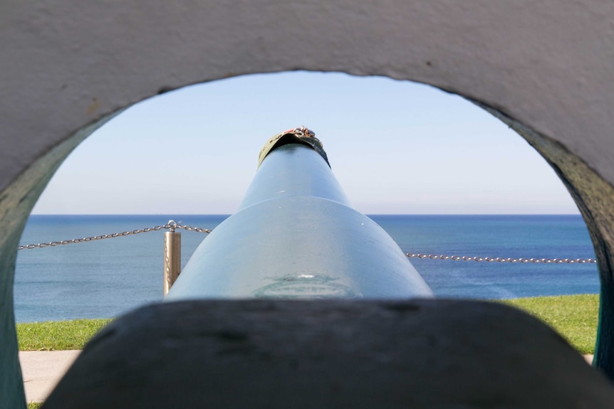 A large gun at Fort Scratchley points out to sea.