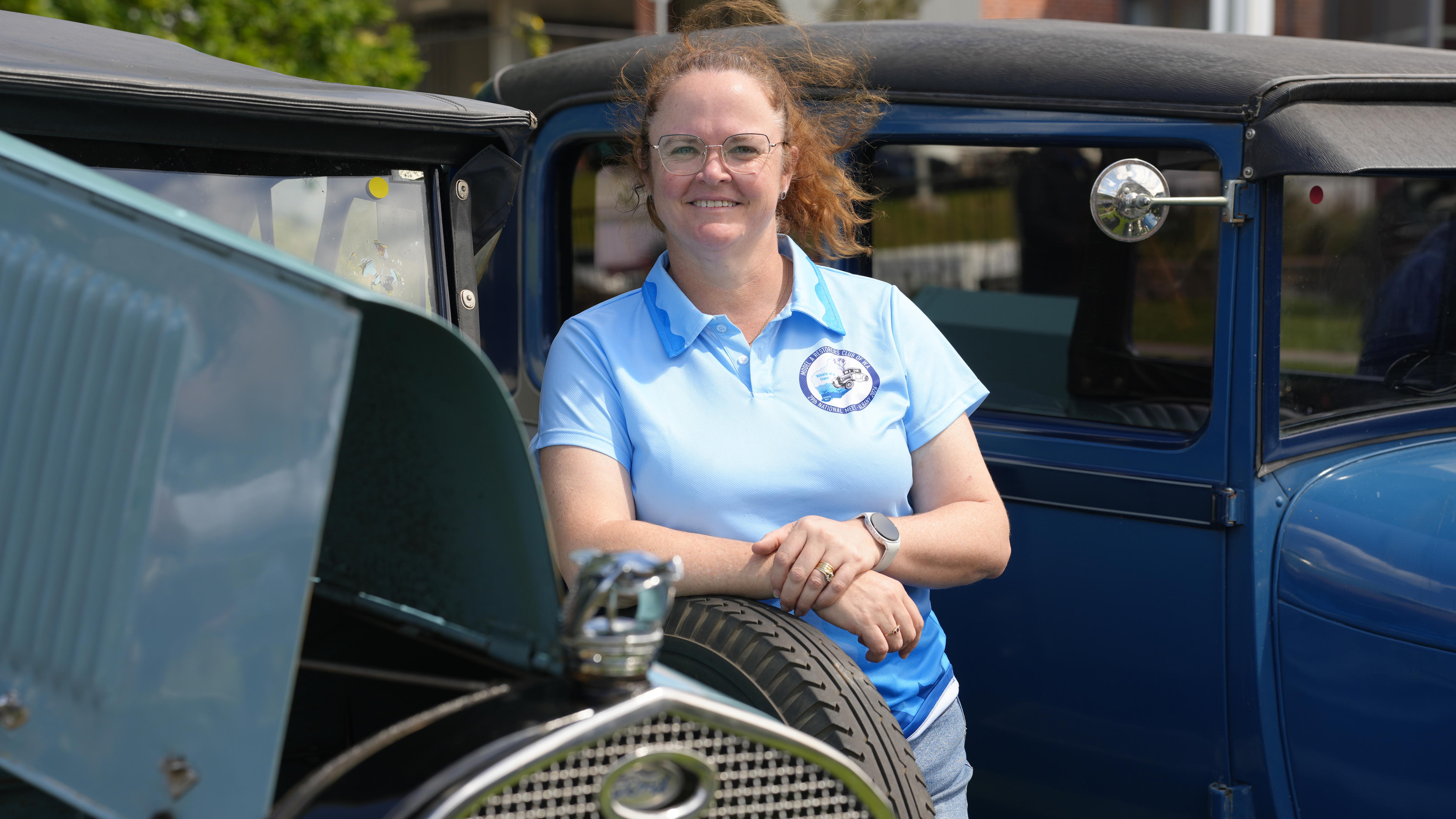 a woman and her vintage car