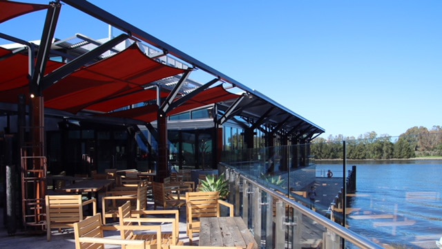 One of Ku De Ta's restaurants with outdoor table settings and views of the Swan River.
