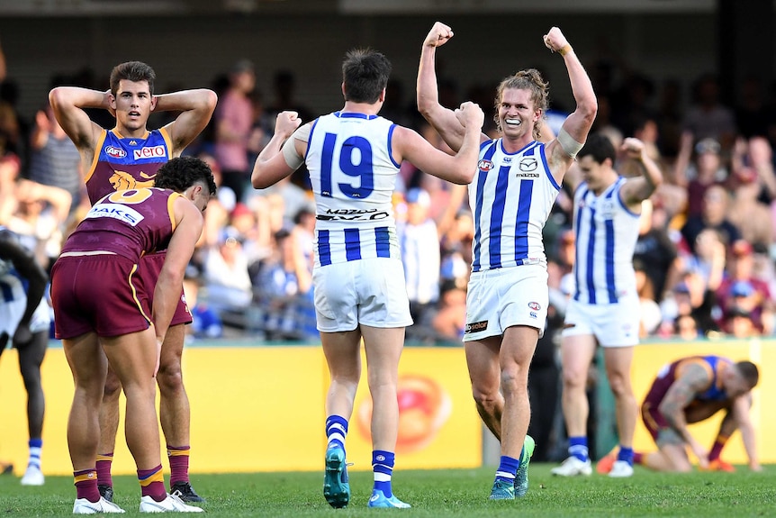 Jed Anderson of North Melbourne (R) celebrate the Kangaroos' win over Brisbane at the Gabba.