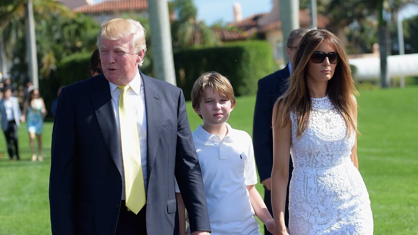 Barron Trump between his parents Donald Trump and Melania Trump