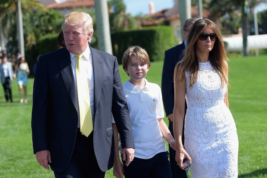 Barron Trump between his parents Donald Trump and Melania Trump