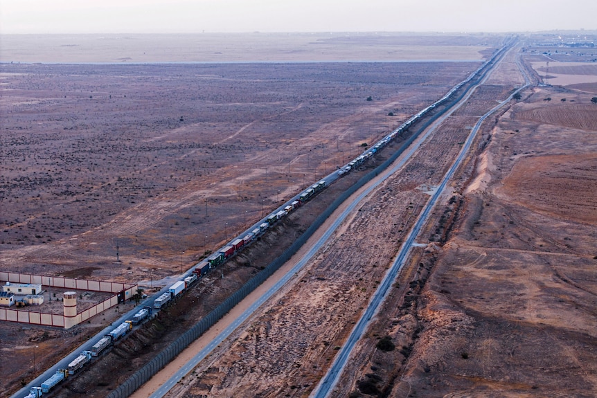 A drone picture of a line of trucks waiting on an Egyptian road along the border with Israel.