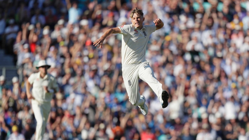 England bowler Sam Curran leaps in the air and loads up a fist pump during a Test match against Australia.