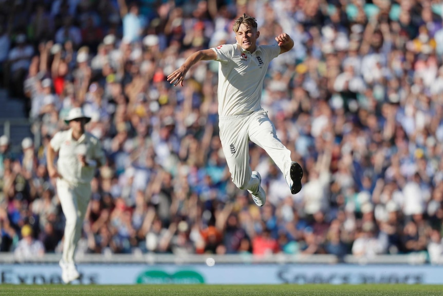 England bowler Sam Curran leaps in the air and loads up a fist pump during a Test match against Australia.