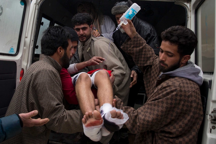 A wounded Kashmiri student is brought for treatment at a hospital.