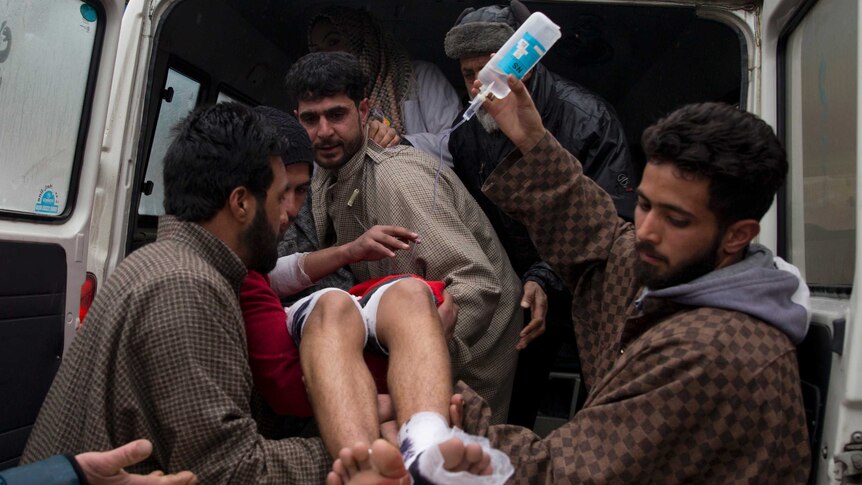 A wounded Kashmiri student is brought for treatment at a hospital.