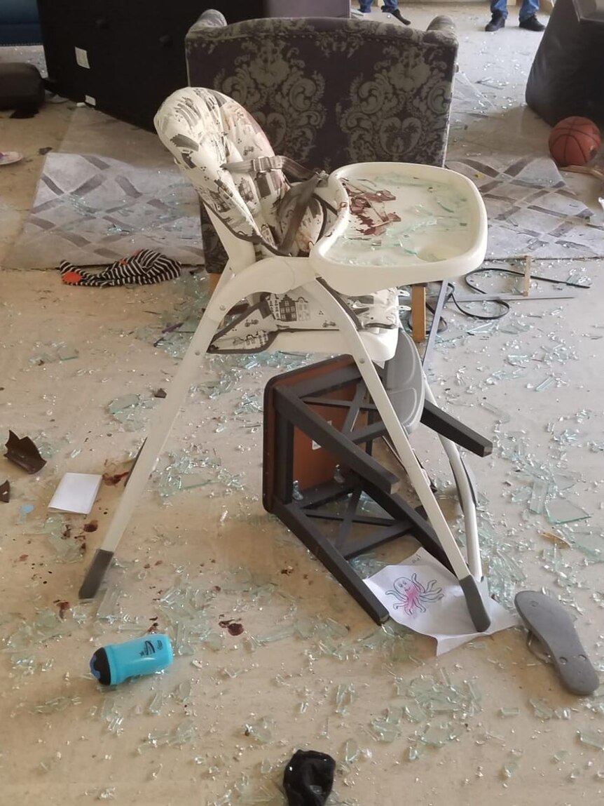 Isaac Oehlers' highchair sits amid broken glass and rubble in their Beirut apartment.