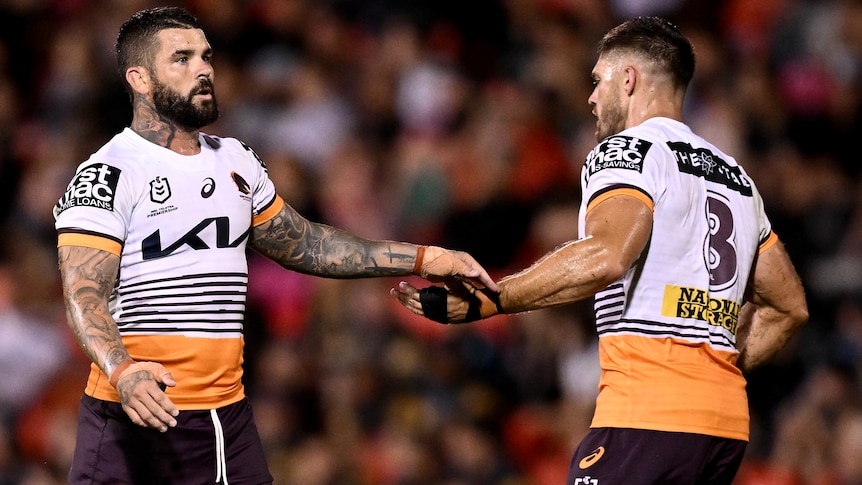 Two Broncos NRL player shake hands after a field goal against Penrith.