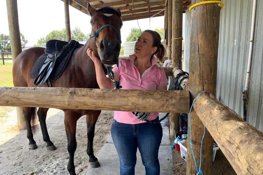 Natasha Johnson and her horse in the stables.