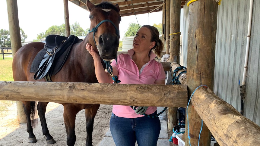 Natasha Johnson and her horse in the stables.