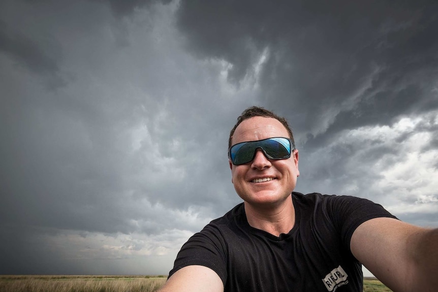 man taking selfie during storm