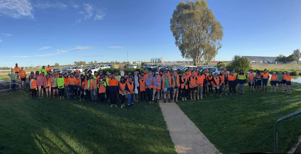 A group shot of GrainCorp staff with the Moree silos in the background
