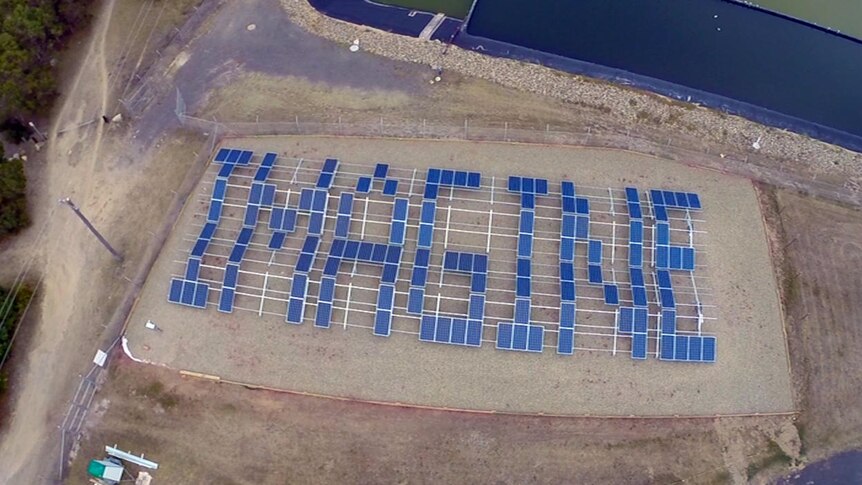 The word 'imagine' spelled out in solar panels, viewed from the air
