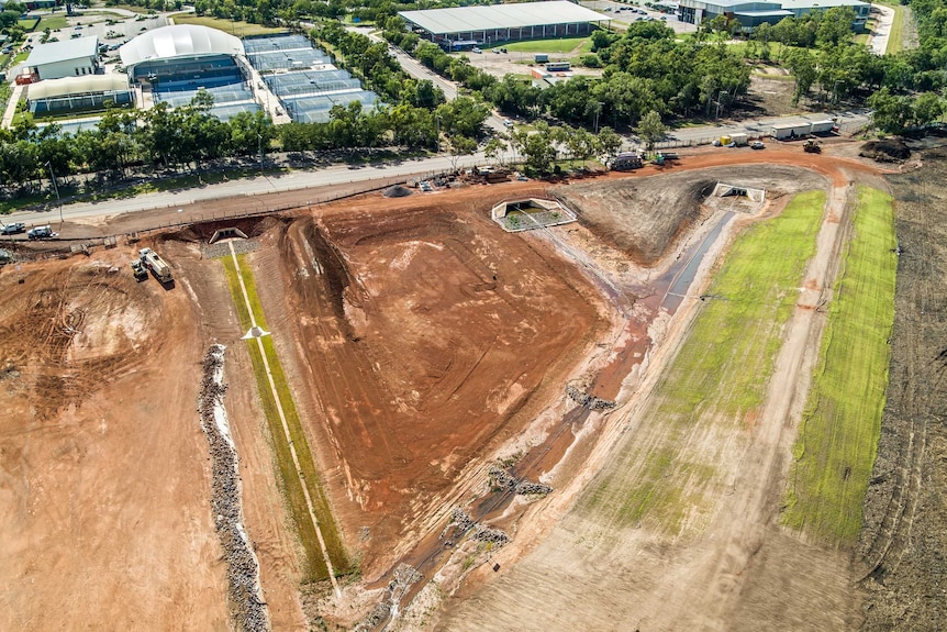 An aerial image of a drain and a large dug-out dirt hole