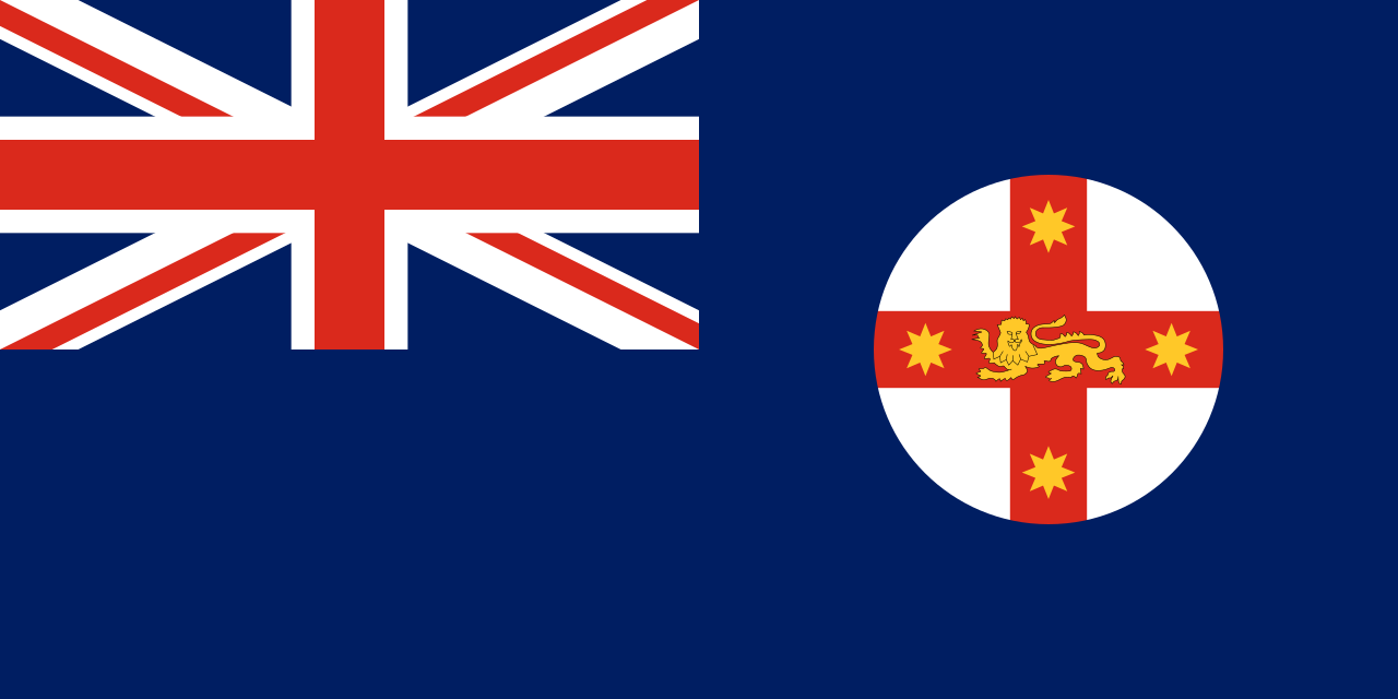 The flag of NSW. Union jack in the top left corner and a circle with a red cross on it, with a gold lion and four stars on the r