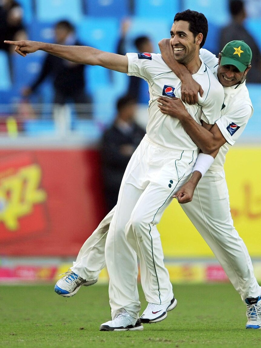 Umar Gul celebrates with Abdur Rehman after dismissing Jonathan Trott.