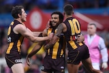 Cyril Rioli is hugged by Bradley Hill and Isaac Smith.