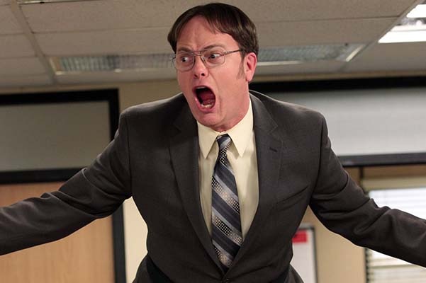 Dwight from The Office television show yells with a red face.