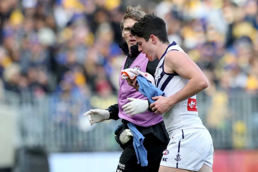 Andrew Brayshaw of the Dockers leaves the field injured against West Coast at Perth Stadium.