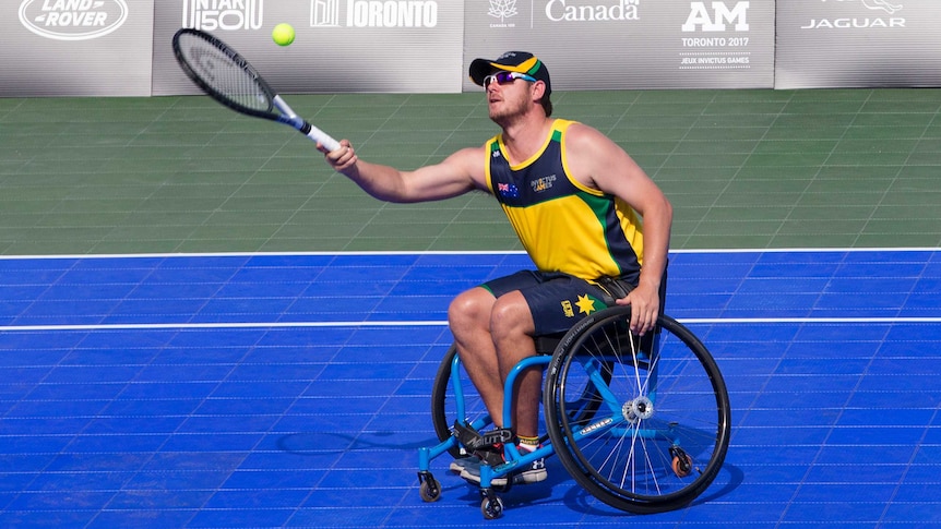 James in a wheelchair hitting a ball with a tennis racquet
