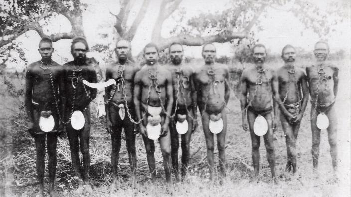 Chained Aboriginal prisoners wearing carved pearlshell.