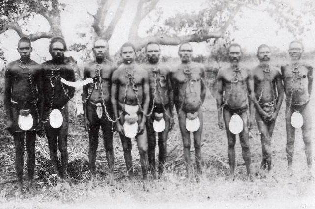 Chained Aboriginal prisoners wearing carved pearlshell.