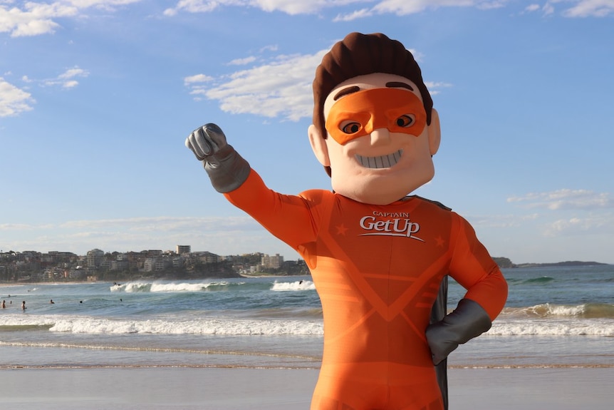 Satirical superhero Captain GetUp on a beach.