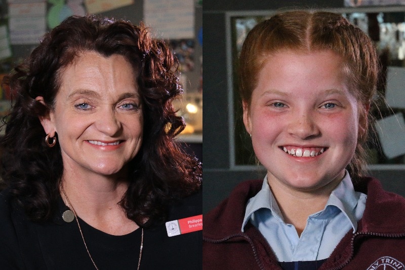 An older woman and a young girl smile at the camera.