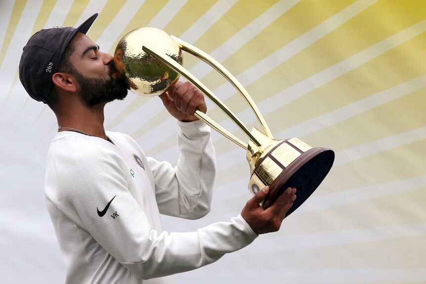India captain Virat Kohli kisses the Border-Gavaskar Trophy after India wins a Test series against Australia.
