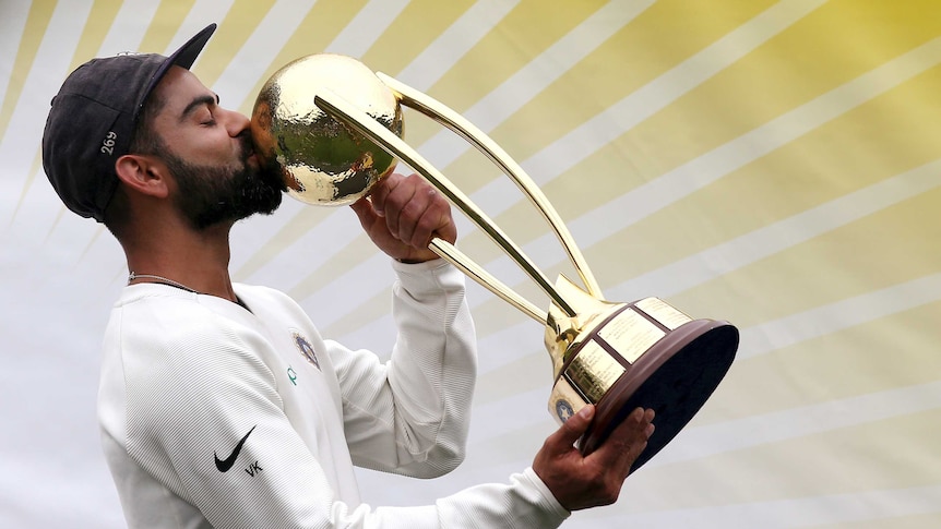 India captain Virat Kohli kisses the Border-Gavaskar Trophy after India wins a Test series against Australia.