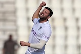 An English male Test cricketer jumps in the air and punches his right fist as he celebrates a wicket against Pakistan.