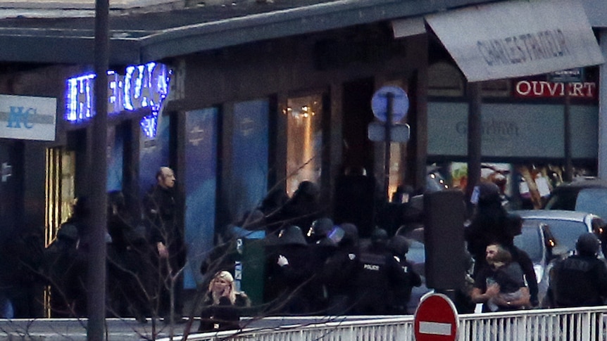 French police special forces evacuate the hostages from the kosher grocery store in Porte de Vincennes.