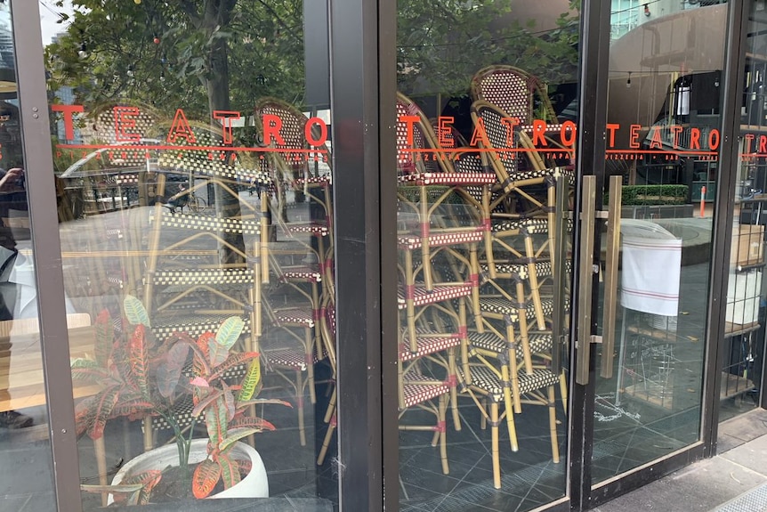 Chairs are all stacked and closed behind glass doors at Teatro restaurant in Southbank.