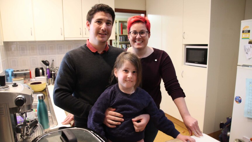 Matt and Chrissie Bruyninckx with their daughter Elena stand in the kitchen at their home in Bateman.