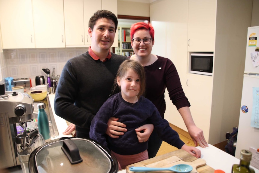 Matt and Chrissie Bruyninckx with their daughter Elena stand in the kitchen at their home in Bateman.