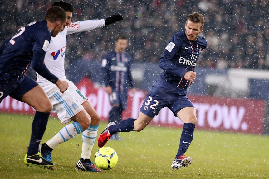Snow battle ... David Beckham vies with Marseille's Andre Pierre Gignac.