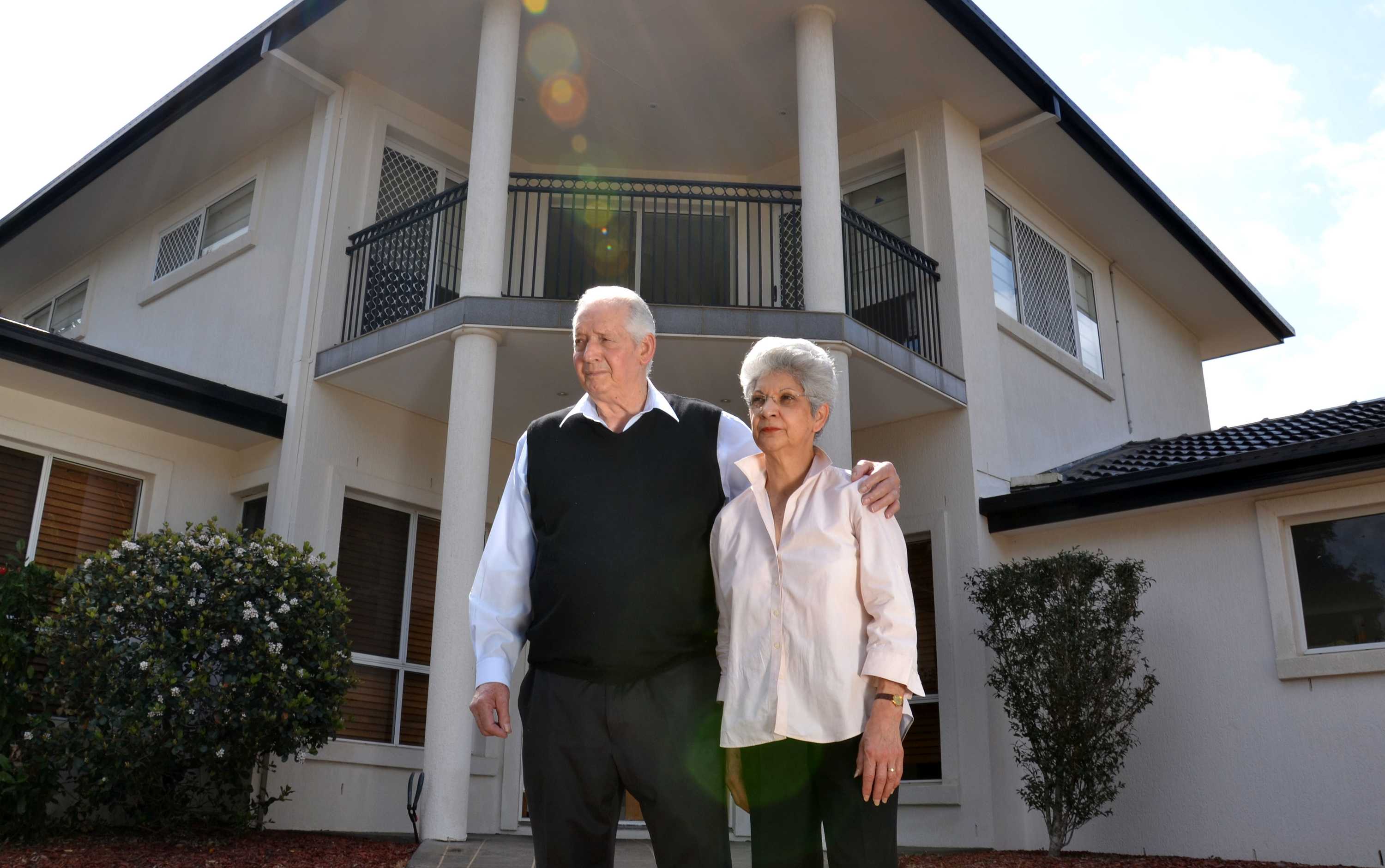 Brisbane fruit shop owners Tony and Doris stand outside their home.