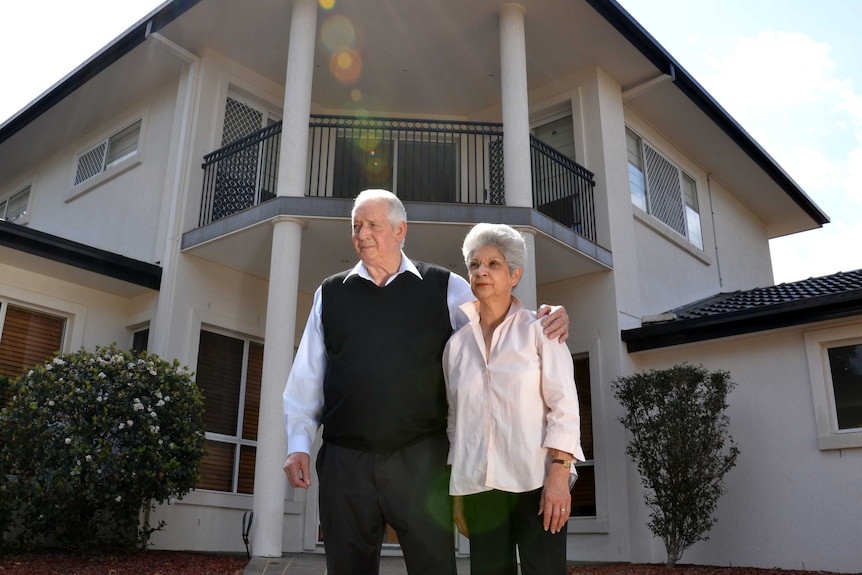 Brisbane fruit shop owners Tony and Doris stand outside their home.