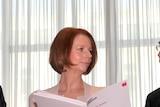 Julia Gillard receives the Critical Decade climate change report from Time Flannery and Will Steffen