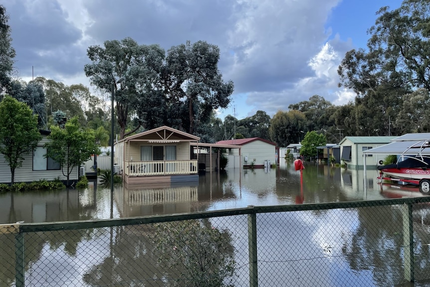 Floodwater surrounds houses in a country town.