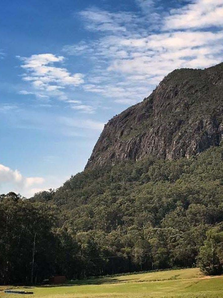 Looking at the large mountain of Mt Tibrogargan from the ground up.