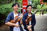 Eddy Chen (left) and Brett Yang holding violins in South Brisbane