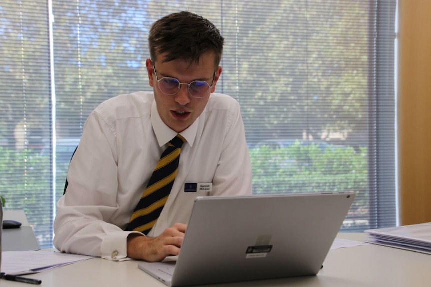 Hamish McLean Christ Church Grammar School teacher working in an office.