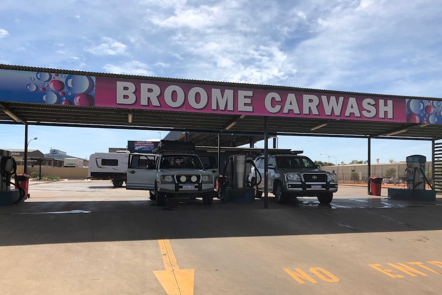 two cars go through a carwash marked Broome carwash