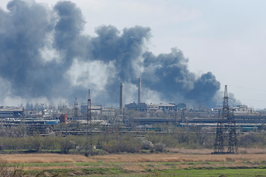 Smoke rises above a plant of Azovstal Iron and Steel Works.