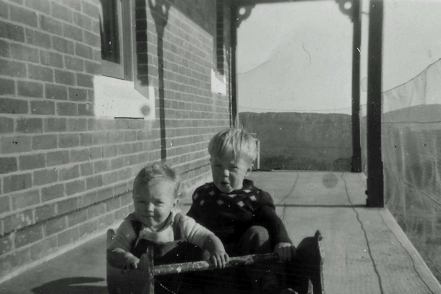 Ms Jackson with her brother on the front veranda which was caged in so the children couldn't escape