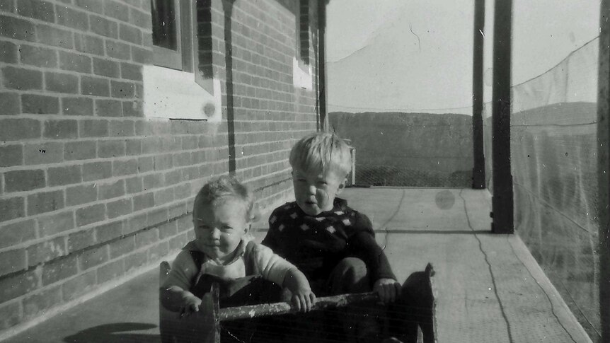 Ms Jackson with her brother on the front veranda which was caged in so the children couldn't escape