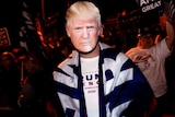 A  person wearing a Donald Trump mask at a protest in Las Vegas.