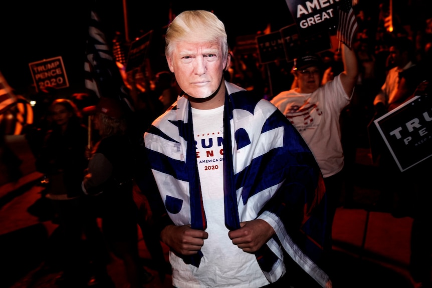 A  person wearing a Donald Trump mask at a protest in Las Vegas.